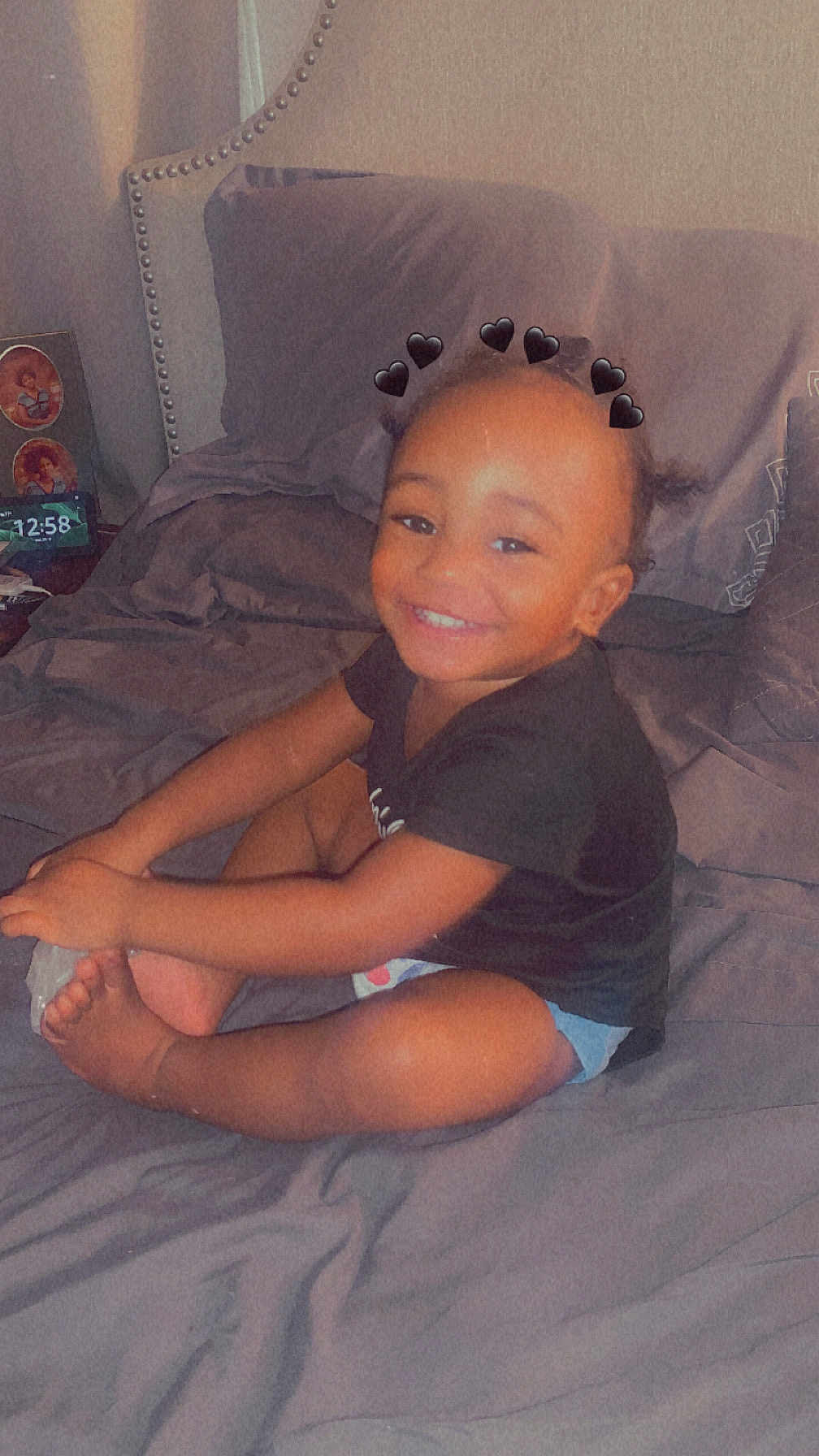 Carvin joined the competition — help win amazing prizes! toddler, child, smiling, bed, bedding, black_heart_filter, hands, feet, hair, indoor, happy, person, cute, clothing, shorts, shirt, pillow, room, portrait, sitting