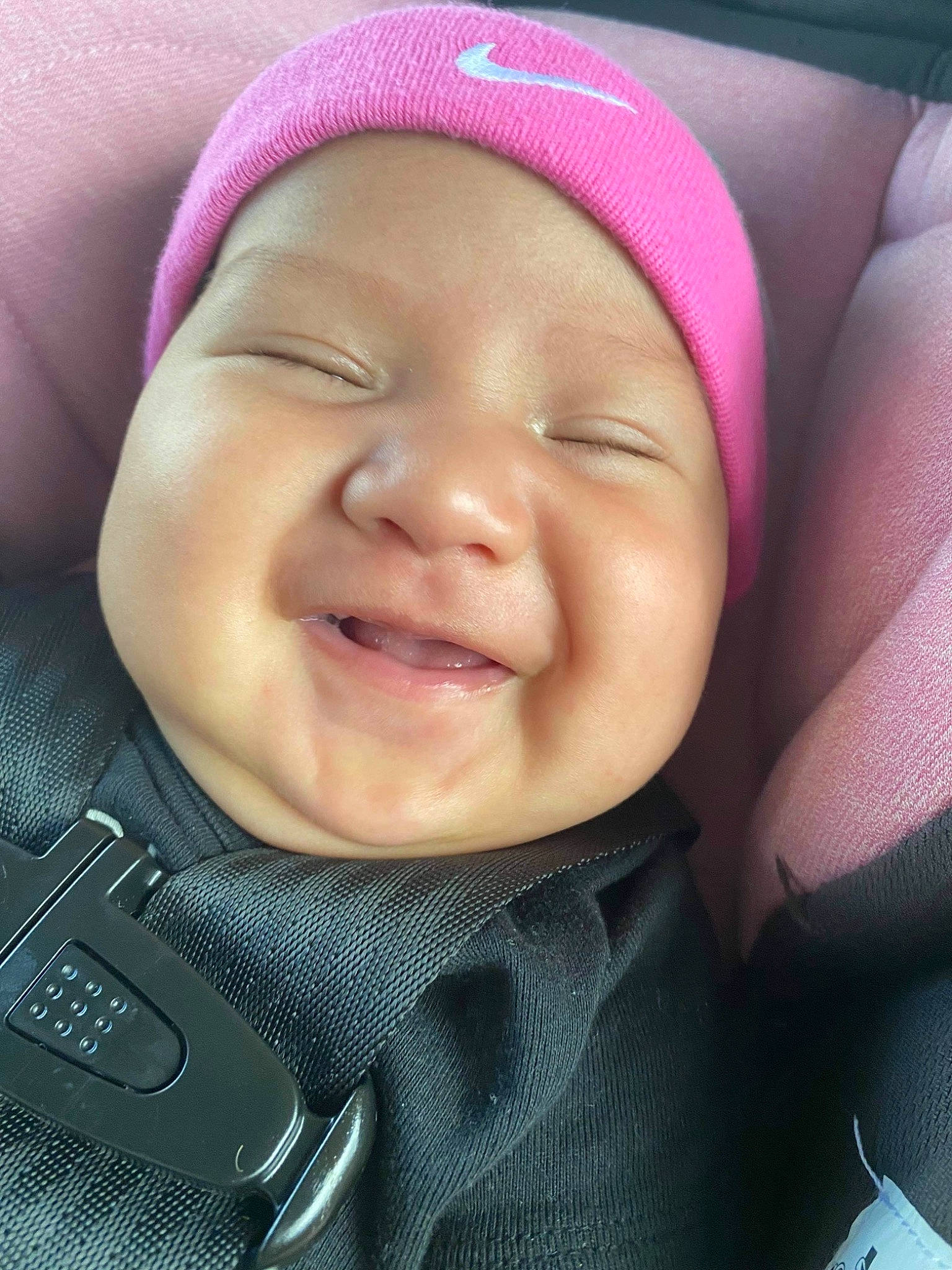Khadijah is registered to the contest to win money with this photo: baby, cheek, chin, comfort, cool, eyebrow, face, facial_expression, finger, gesture, happy, headwear, lip, mouth, nose, person, pink, skin, sleeve, smile
