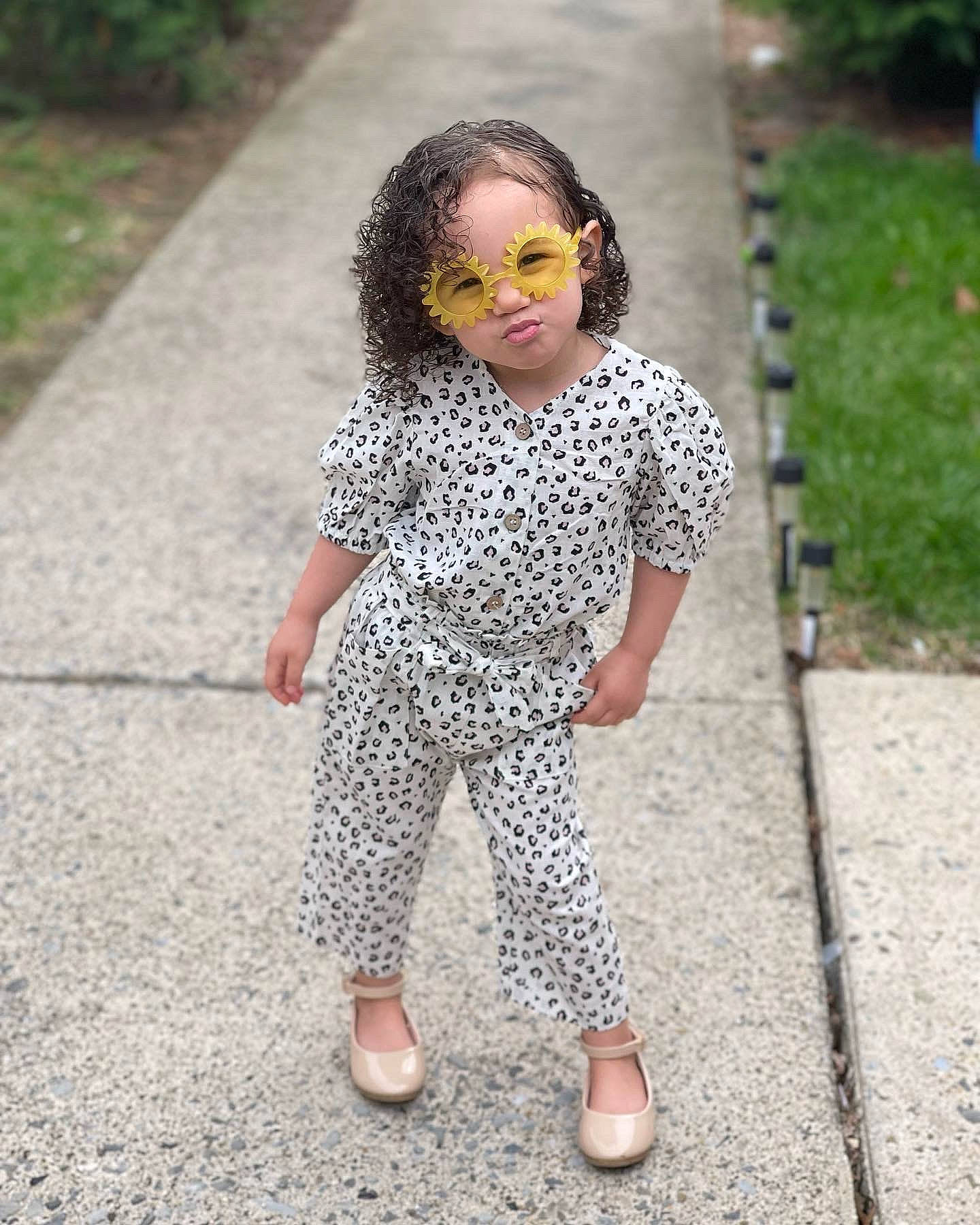Leyani joined the competition — help win amazing prizes! asphalt, child, denim, eyewear, face, grass, head, human_leg, leisure, pattern, person, recreation, road, road_surface, sidewalk, sleeve, street, sunglasses, toddler, vision_care