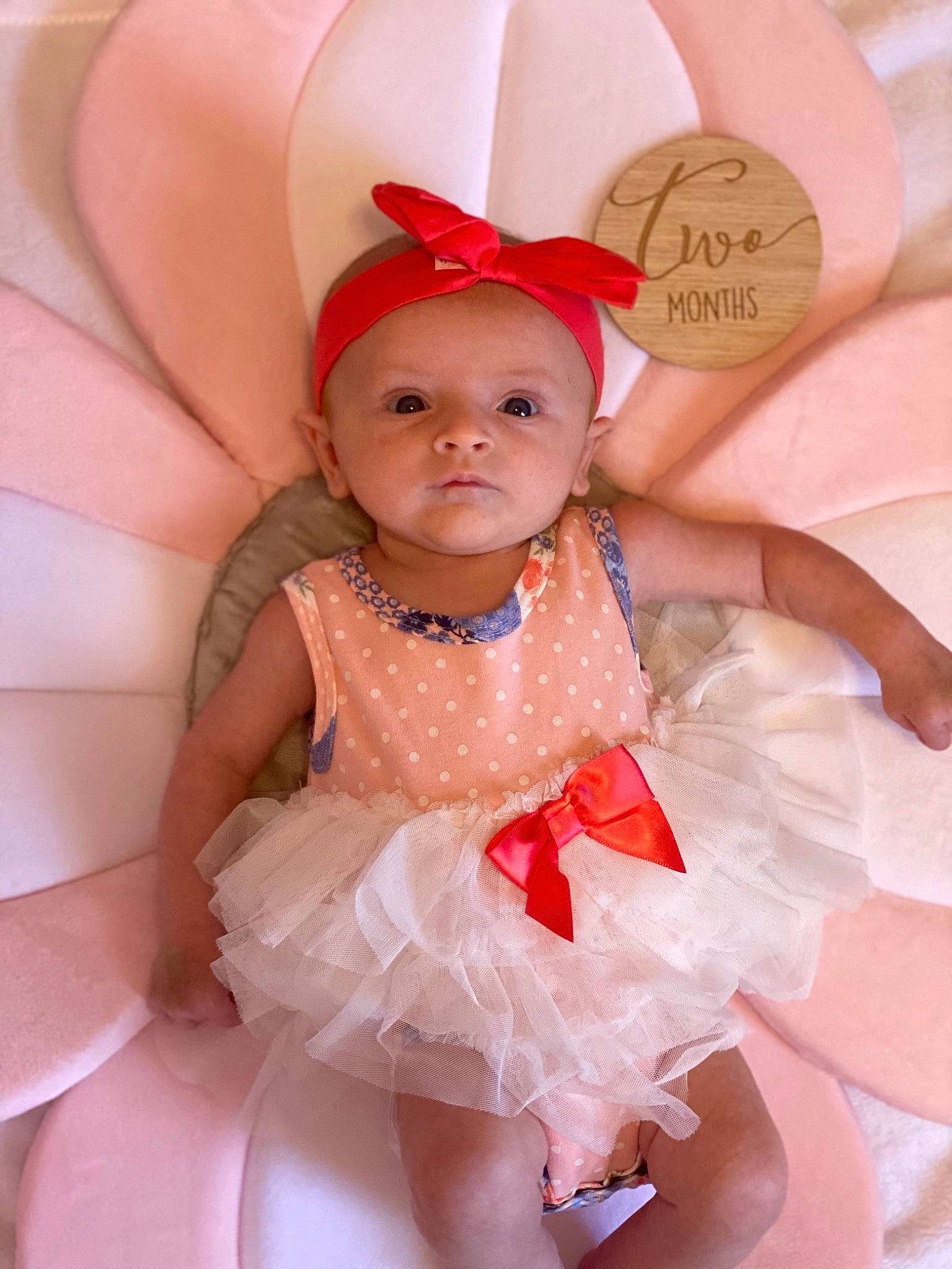 Lyra is registered to the contest to win money with this photo: baby, baby_toddler_clothing, costume_hat, dress, event, face, happy, headband, headpiece, headwear, jewellery, mythical_creature, party_supply, peach, person, petal, pink, ruffle, skin, toddler