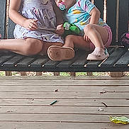 Freya joined the competition — help win amazing prizes! child, children, swing, bench, outdoor, porch, wood, smile, pacifier, clothing, footwear, curly_hair, shorts, dress, relaxing, siblings, cute, daylight, playful, resting