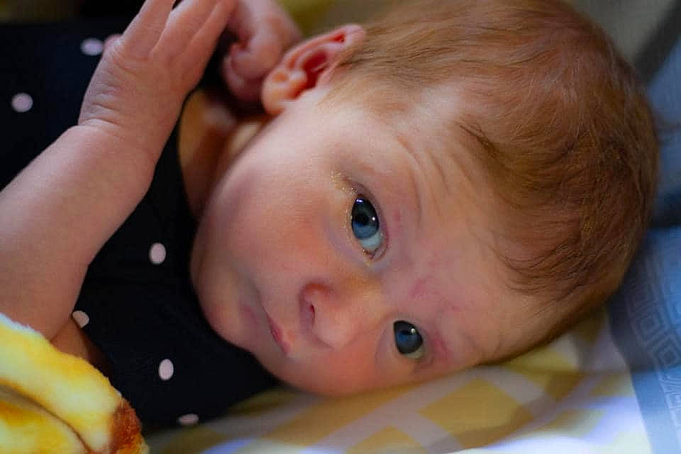 Adalyn is registered to the contest to win money with this photo: arm, baby, cheek, ear, eye, eyebrow, eyelash, face, facial_expression, gesture, hand, happy, iris, lip, mouth, neck, nose, person, product, skin