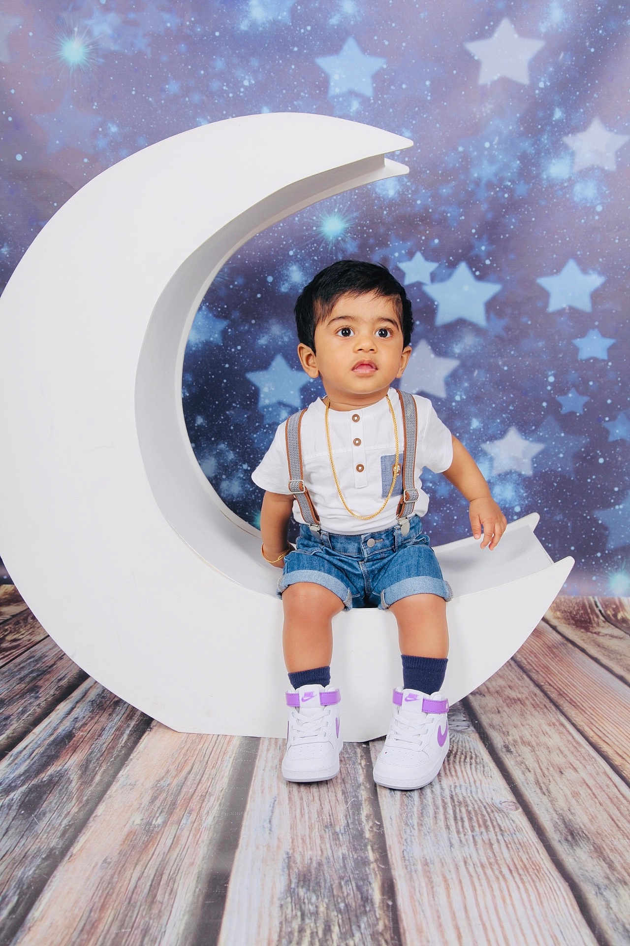 Diyash participe au concours pour gagner de l'argent avec cette photo : toddler, child, white_shoes, denim_shorts, suspenders, crescent_moon, starry_background, wooden_floor, indoors, portrait, cute, fashion, studio_photo, props, flooring, stars, baby, person, sitting, casual_clothing
