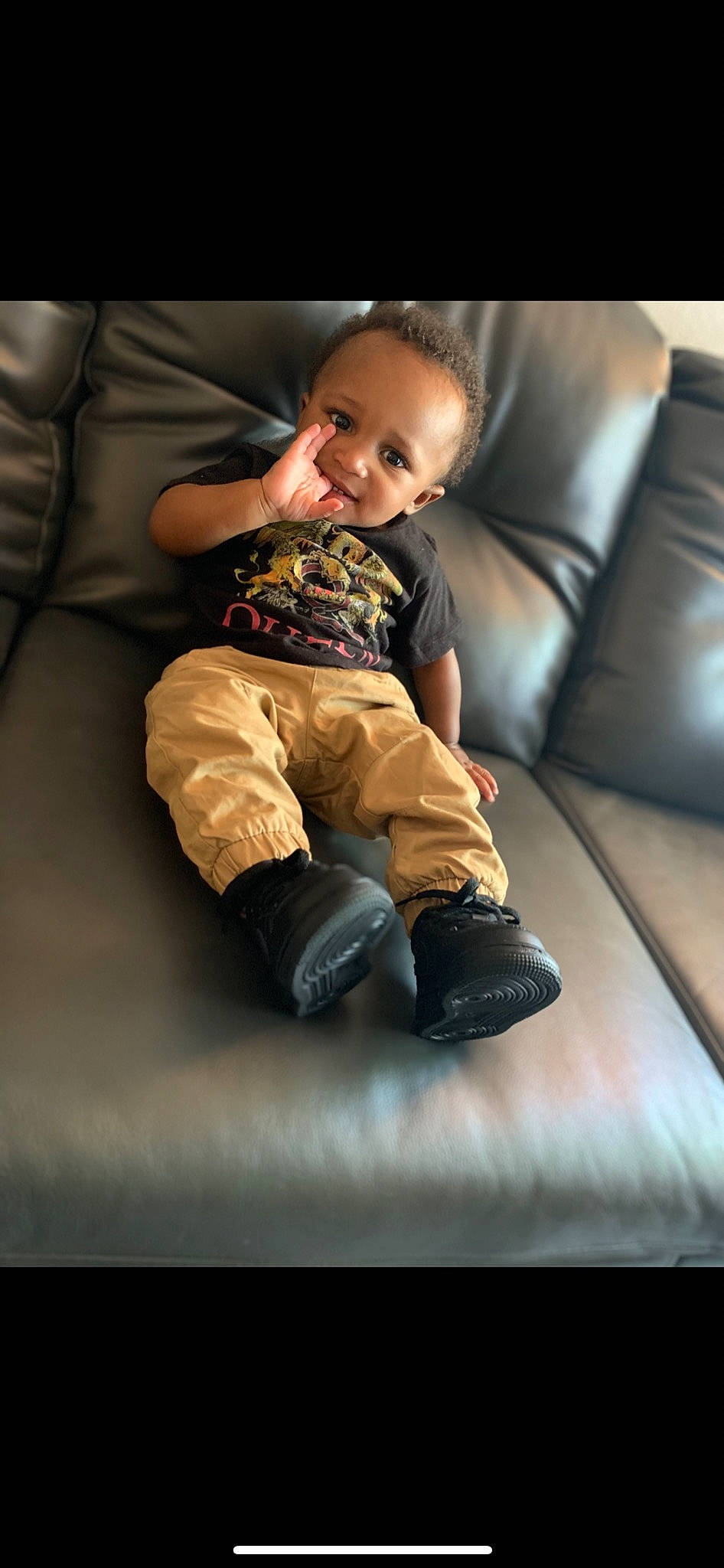 Dontez is registered to the contest to win money with this photo: baby, baby_toddler_clothing, comfort, couch, eye, face, finger, flash_photography, floor, flooring, fun, human_body, human_leg, knee, leg, person, sleeve, smile, tints_and_shades, toddler