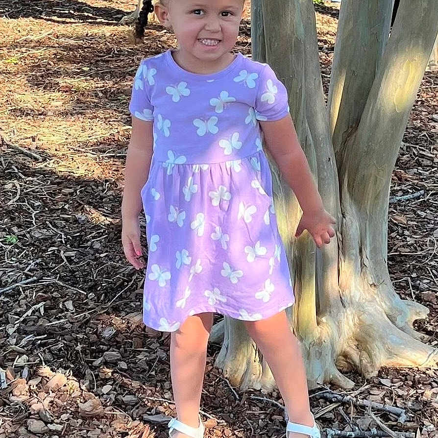 Ryliegh is registered to the contest to win money with this photo: child, clothing, dress, face, female, footwear, girl, grass, head, jeans, person, photography, plant, portrait, sandal, shoe, sitting, sleeve, standing, tree