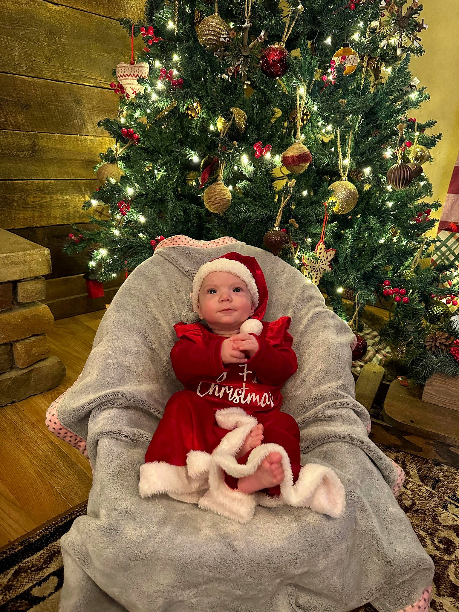 Oakley joined the competition — help win amazing prizes! baby, baby_toddler_clothing, christmas, christmas_decoration, christmas_ornament, christmas_tree, event, evergreen, facial_expression, grass, hat, headwear, holiday, holiday_ornament, lap, leaf, ornament, person, plant, standing