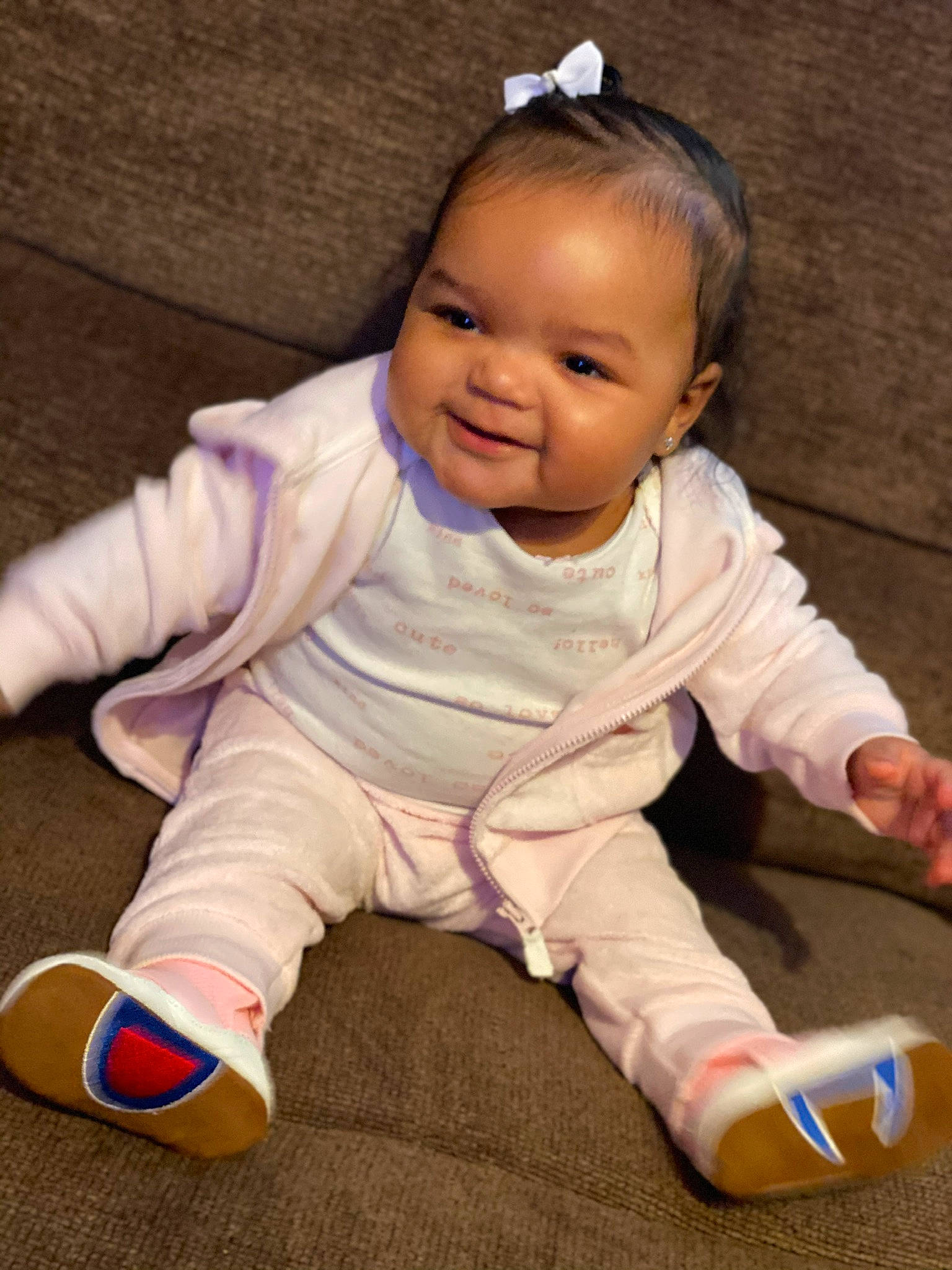 Amina is registered to the contest to win money with this photo: baby, baby_toddler_clothing, cheek, comfort, eye, finger, floor, flooring, happy, hardwood, head, iris, nose, person, skin, sleeve, smile, thumb, toddler, white