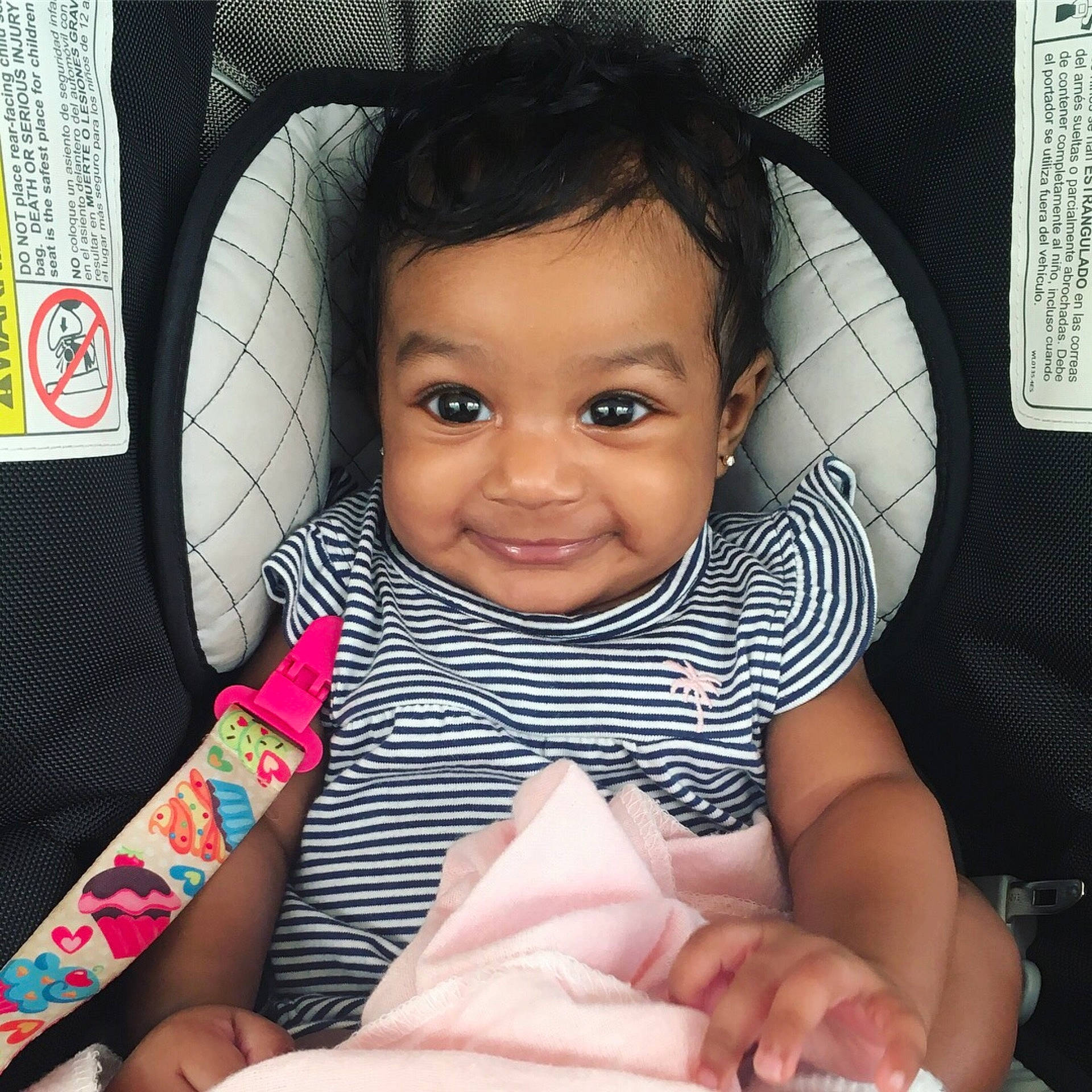 Priya is registered to the contest to win money with this photo: black_hair, car_seat, cheek, child, cool, day, eye, face, finger, girl, head, infant, joy, nose, person, product, sitting, skin, smile, toddler