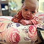 Mckenna joined the competition — help win amazing prizes! baby, infant, face, hands, pillow, floral_pattern, indoor, cozy, soft_lighting, expression, child, person, home, blanket, cute, closeup, portrait, newborn, resting, curious