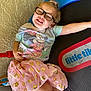 child, girl, glasses, smiling, sitting, minnie_mouse, tshirt, pink_skirt, golden_flowers, play_structure, little_tikes, indoor, happy, cute, toy, playtime, casual_clothing, fun, leisure, portrait