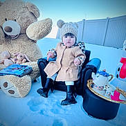 Eliette is registered to the contest to win money with this photo: boots, child, coat, cute, fashion, fence, giant_teddy_bear, hat, miniature_chair, mirror, outdoor, plush_toy, portrait, snow, snowman, tea_set, toddler, toy_bear, toy_rabbit, winter_clothing
