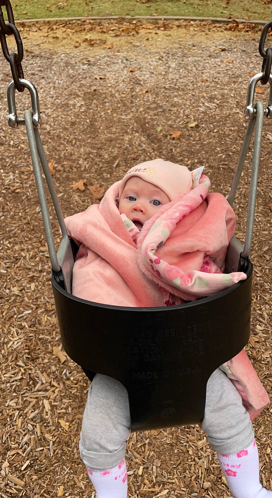 Katrina is registered to the contest to win money with this photo: baby, baby_carriage, baby_products, child, city, comfort, fashion_accessory, fun, grass, happy, hat, leisure, people_in_nature, person, pink, play, product, recreation, sitting, swing