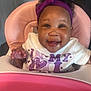 Naailah joined the competition — help win amazing prizes! baby, child, high_chair, headband, purple, white_shirt, drool, smiling, happy, indoor, person, face, cute, infant, young_child, pink, furniture, seat, portrait, clothing