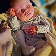 Daisy joined the competition — help win amazing prizes! baby, sleeping, infant, cozy, blanket, soft_lighting, peaceful, cute, clothing, hand, face, portrait, indoors, warm_colors, toddler, nap, resting, child, closeup, cute_outfit