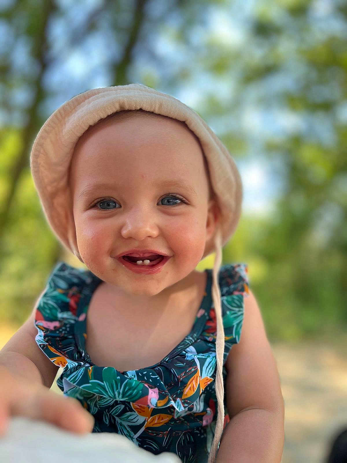 Lana participe au concours pour gagner de l'argent avec cette photo : toddler, child, smiling, hat, sunhat, floral_dress, outdoor, nature, portrait, happy, baby, face, blue_eyes, summer, cute, young_child, closeup, daylight, skin, person