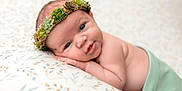 Fern joined the competition — help win amazing prizes! baby, blanket, child, closeup, crown, cute, expression, face, green_cloth, hand, headwear, indoors, infant, lying_down, newborn, pattern, portrait, skin, soft_light, succulent