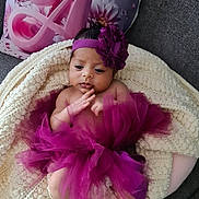 Angèl participe au concours pour gagner de l'argent avec cette photo : baby, blanket, couch, crown, cute, decorative_pillow, flower_accessory, headband, indoors, infant, knitted_blanket, letter_a, newborn, pillow, portrait, purple_tutu, relaxed, skin, small_feet, sofa