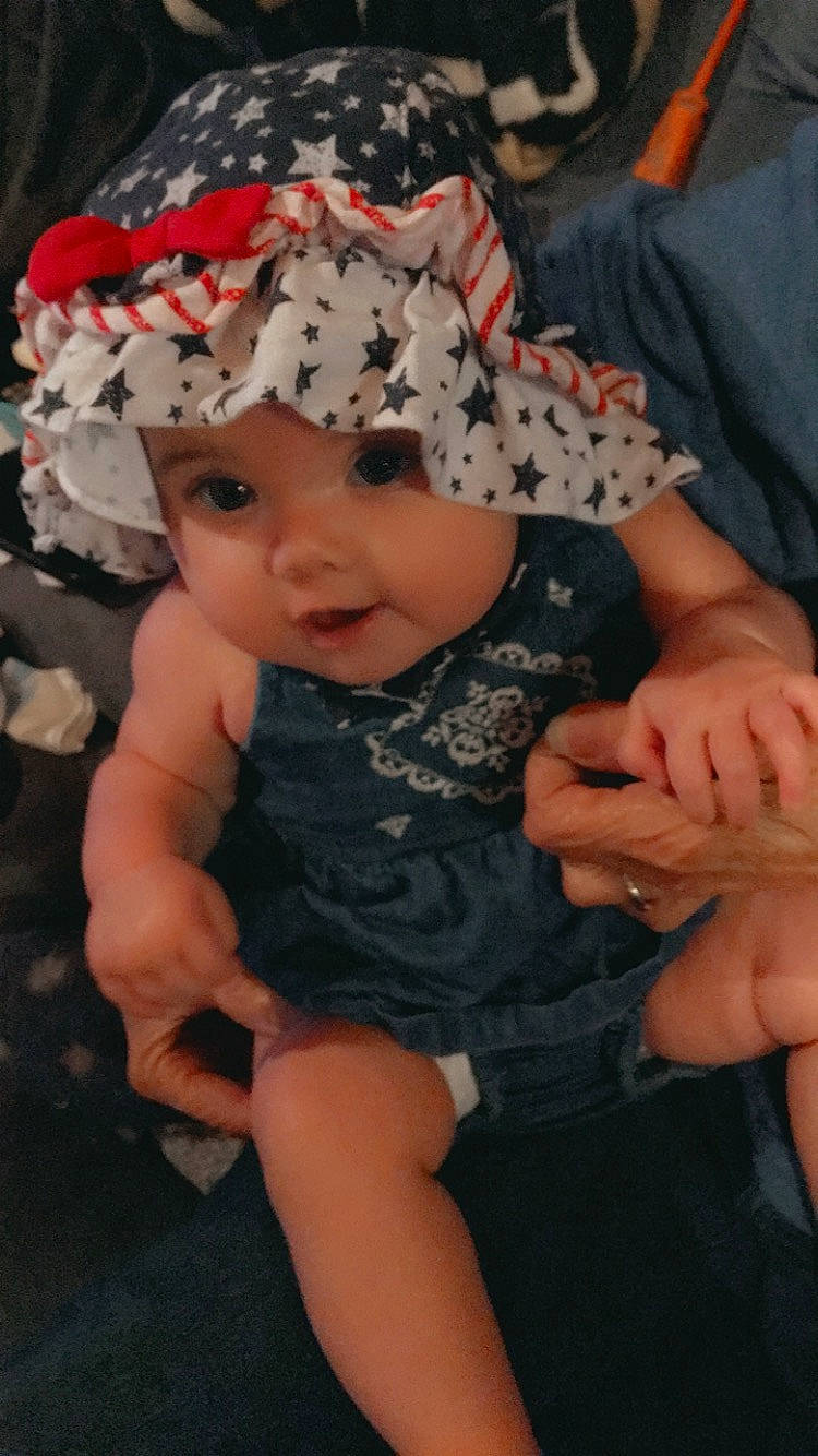 Daisey is registered to the contest to win money with this photo: baby, bonnet, cheek, child, fashion_accessory, finger, hair_accessory, headgear, headpiece, headwear, person, toddler