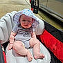 Chase joined the competition — help win amazing prizes! baby, child, infant, hat, onesie, stroller, inflatable_cushion, outdoor, sunhat, pavement, car, cute, smiling, sitting, plump, person, daylight, casual_clothing, baby_clothes, happy