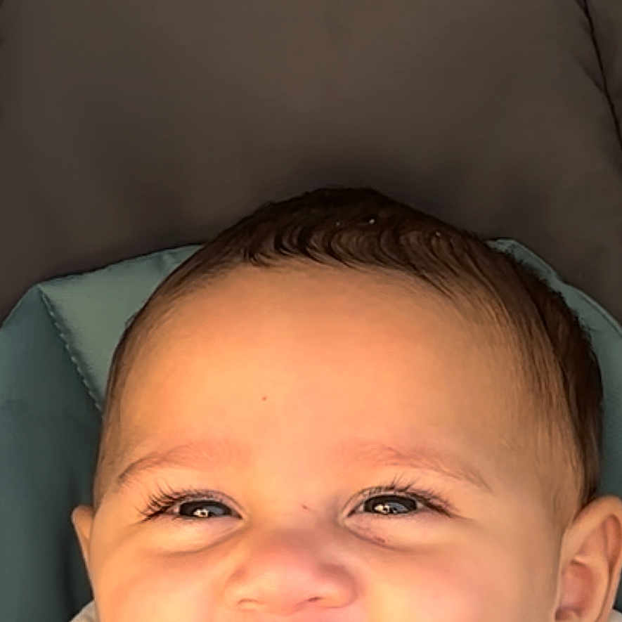 Yusif joined the competition — help win amazing prizes! baby, baby_bib, baby_face, bib, child, closeup, clothing, cute, eyelashes, face, happy, head, infant, person, portrait, seat, skin, smile, stroller, young