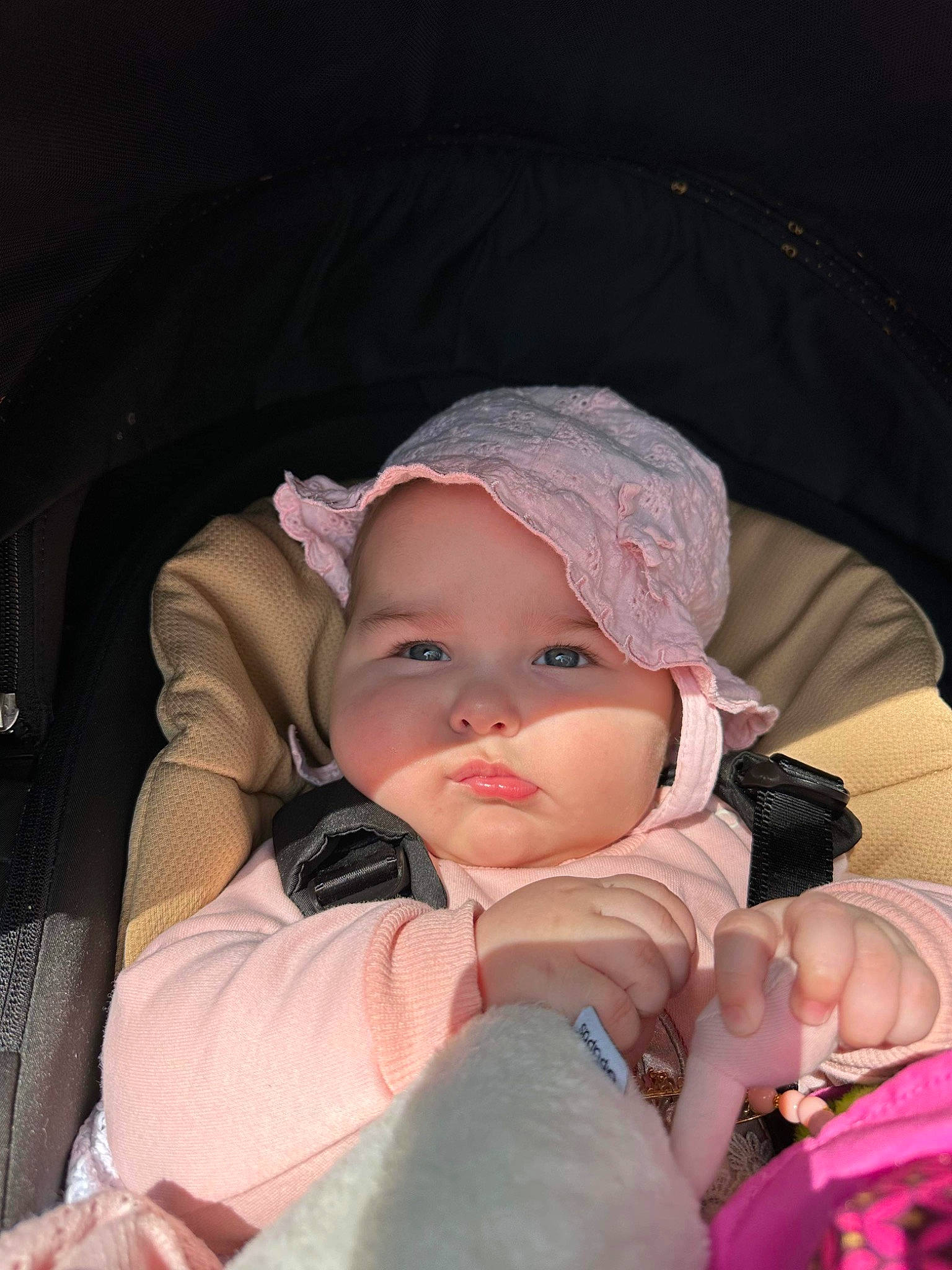 Edalyn is registered to the contest to win money with this photo: baby, baby_carriage, baby_products, baby_toddler_clothing, beanie, cap, car_seat, cheek, child, comfort, fashion_accessory, flash_photography, fun, headwear, lap, mouth, person, pink, sitting, skin