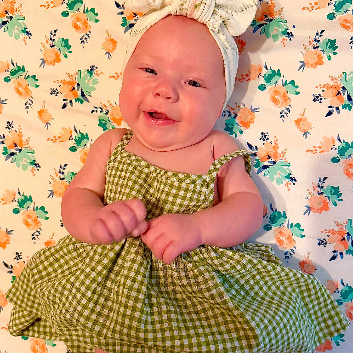 Maebrie Mahryn joined the competition — help win amazing prizes! baby, smiling, green_dress, headband, bow, floral_pattern, blanket, cute, infant, portrait, happy, child, lying_down, cheerful, skin, person, indoors, closeup, baby_girl, fashion
