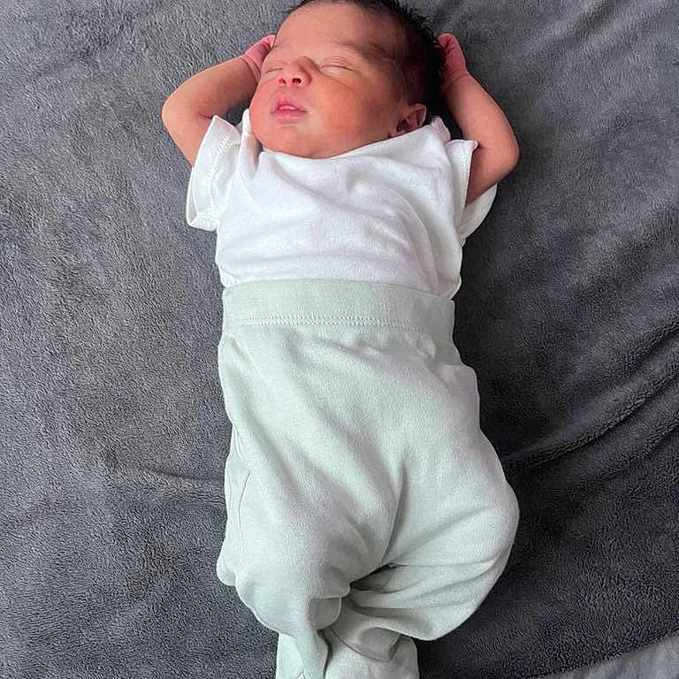 Ayanna is registered to the contest to win money with this photo: baby, child, comfortable, cozy, cute, human, indoors, infant, lying_down, newborn, peaceful, person, portrait, relaxed, resting, sleeping, small, soft_blanket, white_clothing, young