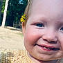 toddler, child, face, smile, flower, yellow_flower, outdoor, nature, grass, tree, blue_eyes, cheeks, baby_teeth, close_up, portrait, happy, cute, skin, head, hair