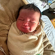 Rimington is registered to the contest to win money with this photo: baby, newborn, infant, swaddled, blanket, pacifier, sleeping, smile, face, hair, cheeks, closeup, portrait, cozy, bedroom, bedding, pillow, blanket_texture, soft, happy