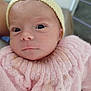 Syléa a rejoint le concours — aidez-le/la à gagner de superbes lots ! baby, newborn, infant, face, hat, knitted, pink_sweater, closeup, portrait, person, skin, eyes, cute, soft, warm, child, human, headwear, apparel, indoors