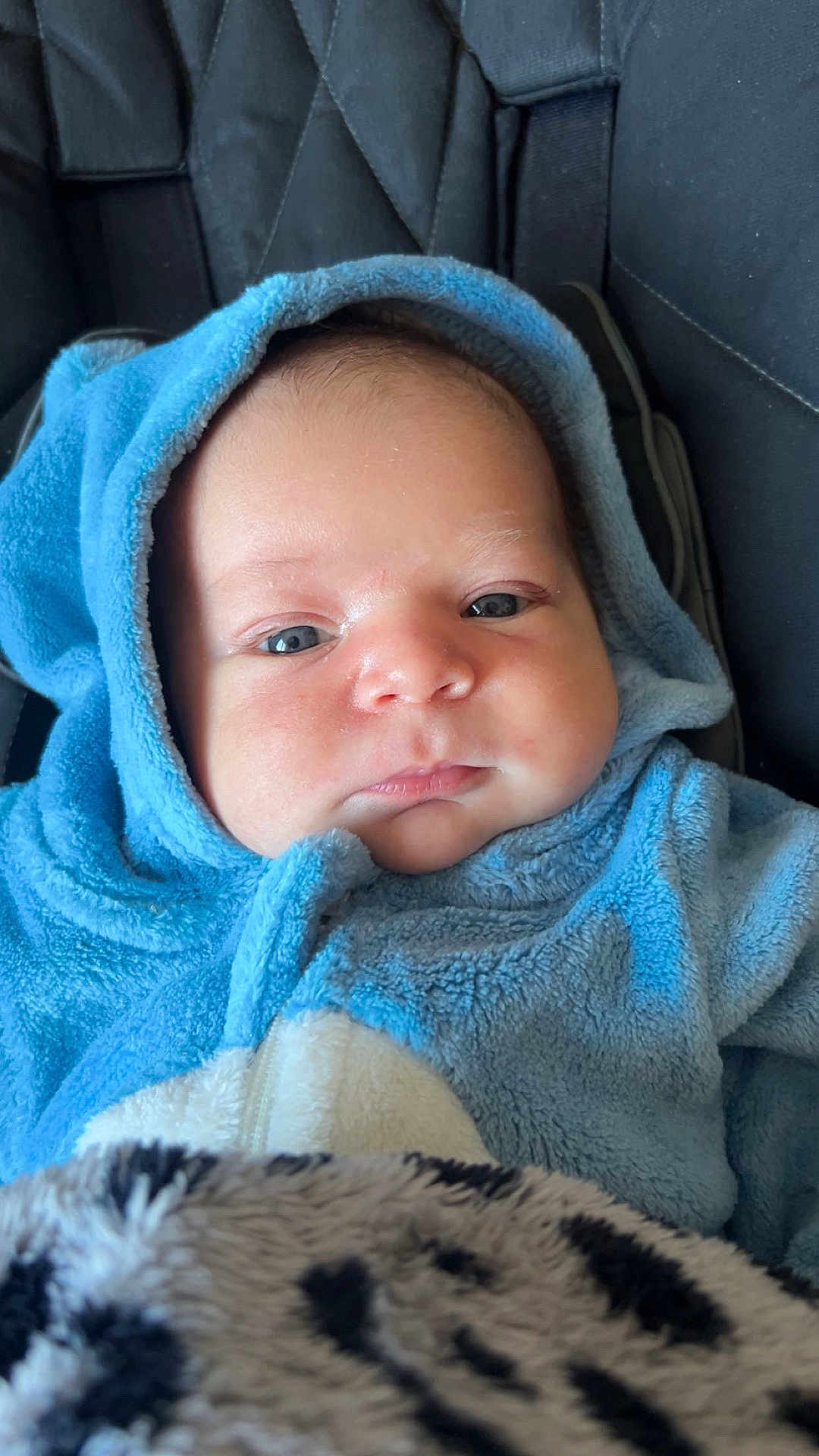 Ayden participe au concours pour gagner de l'argent avec cette photo : baby, infant, blue_hoodie, blanket, cozy, cute, face, child, portrait, closeup, warm, soft_texture, fuzzy, indoor, newborn, clothing, person, headwear, seated, expression