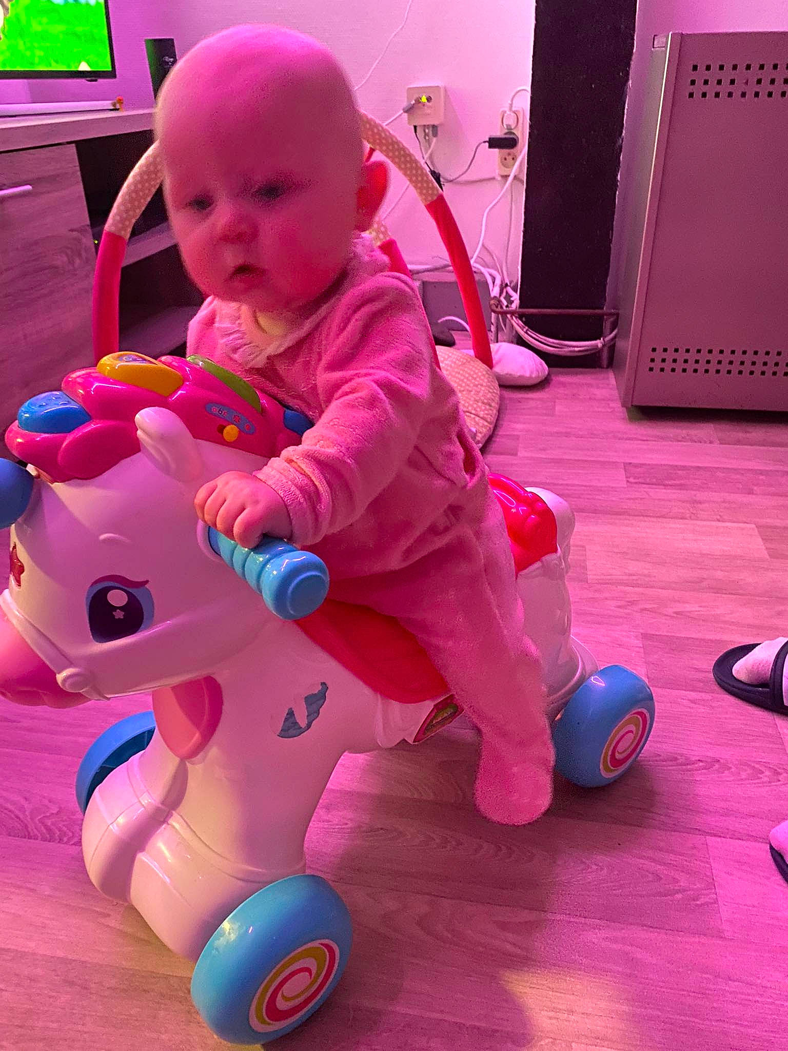 Olivia participe au concours pour gagner de l'argent avec cette photo : baby, baby_toddler_clothing, child, electric_blue, flooring, fun, green, happy, magenta, person, photograph, pink, purple, red, riding_toy, shoe, snapshot, toddler, toy, violet