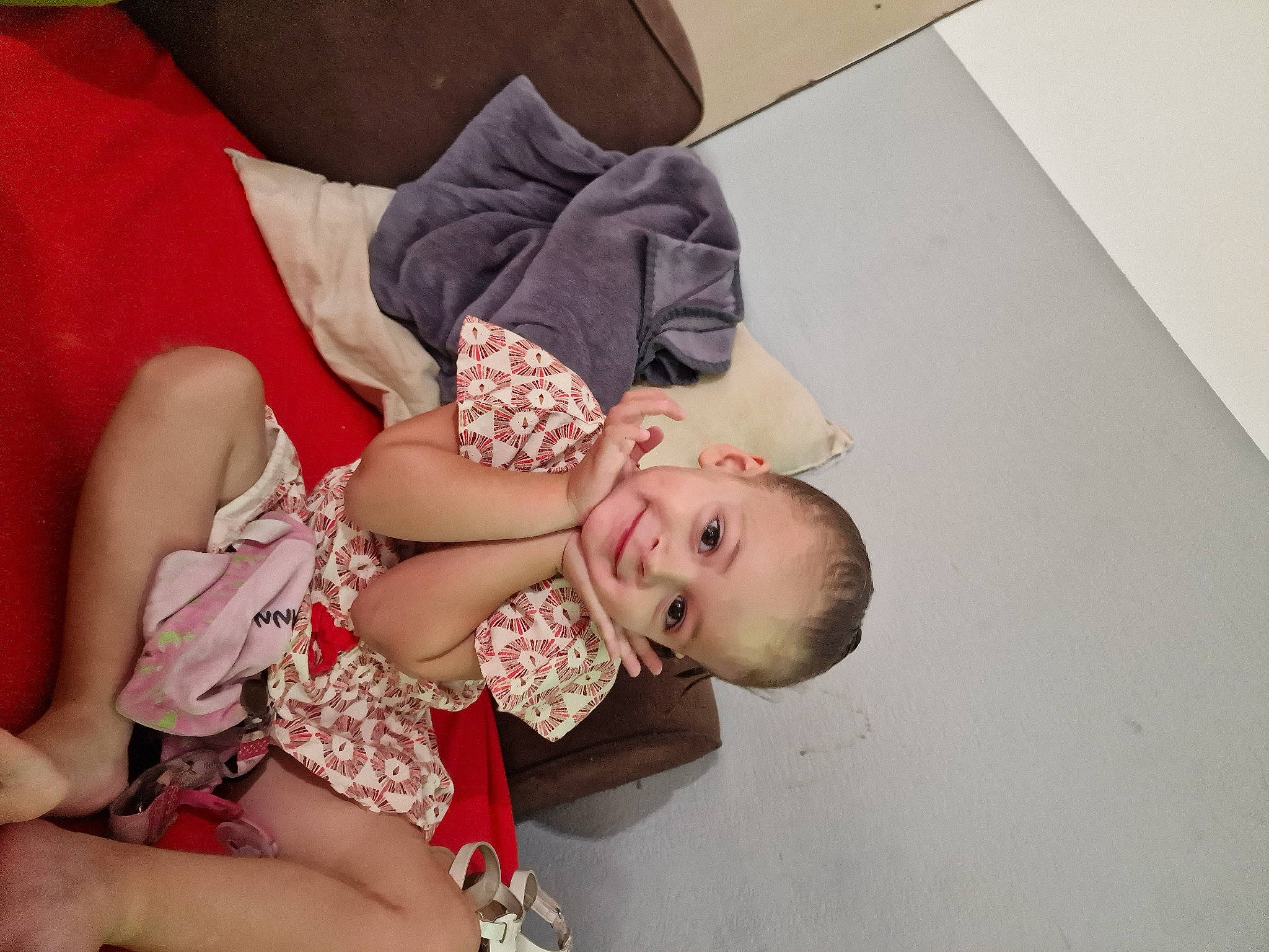 Shanna participe au concours pour gagner de l'argent avec cette photo : baby, baby_toddler_clothing, child, comfort, dress, flooring, gesture, hand, happy, human_body, human_leg, jewellery, joy, lap, leg, nail, pattern, person, sitting, smile