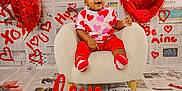 Zanari joined the competition — help win amazing prizes! baby, balloon, child, decoration, festive, headband, heart_balloon, heart_pattern_clothing, love_sign, newspaper_background, plush_chair, portrait, props, red_color, sitting, smiling, socks, studio_shot, toddler, valentine_theme