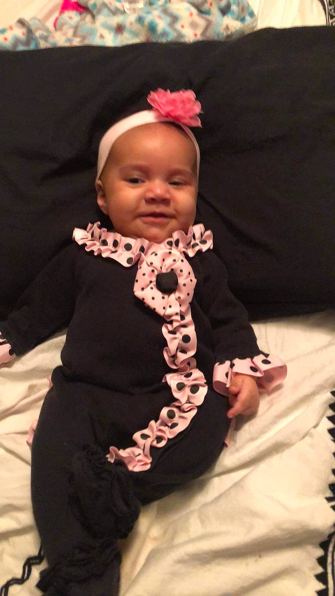 Harmony is registered to the contest to win money with this photo: baby, baby_toddler_clothing, event, fashion_accessory, fashion_design, finger, formal_wear, fun, gesture, hair_accessory, happy, headpiece, jewellery, lip, magenta, nail, person, pink, sleeve, smile