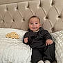 Ibrahim participe au concours pour gagner de l'argent avec cette photo : baby, bed, child, comfortable, cute, face, happy, headboard, hoodie, indoor, infant, milestone_sign, pants, person, pillow, sitting, smiling, soft, white_socks, wooden_sign