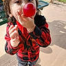 balloon, boy, casual_clothing, child, closeup, concrete_floor, curious, daylight, fun, grass, outdoor, park, picnic_table, plaid_shirt, playful, red_shirt, shadow, sneakers, standing, young