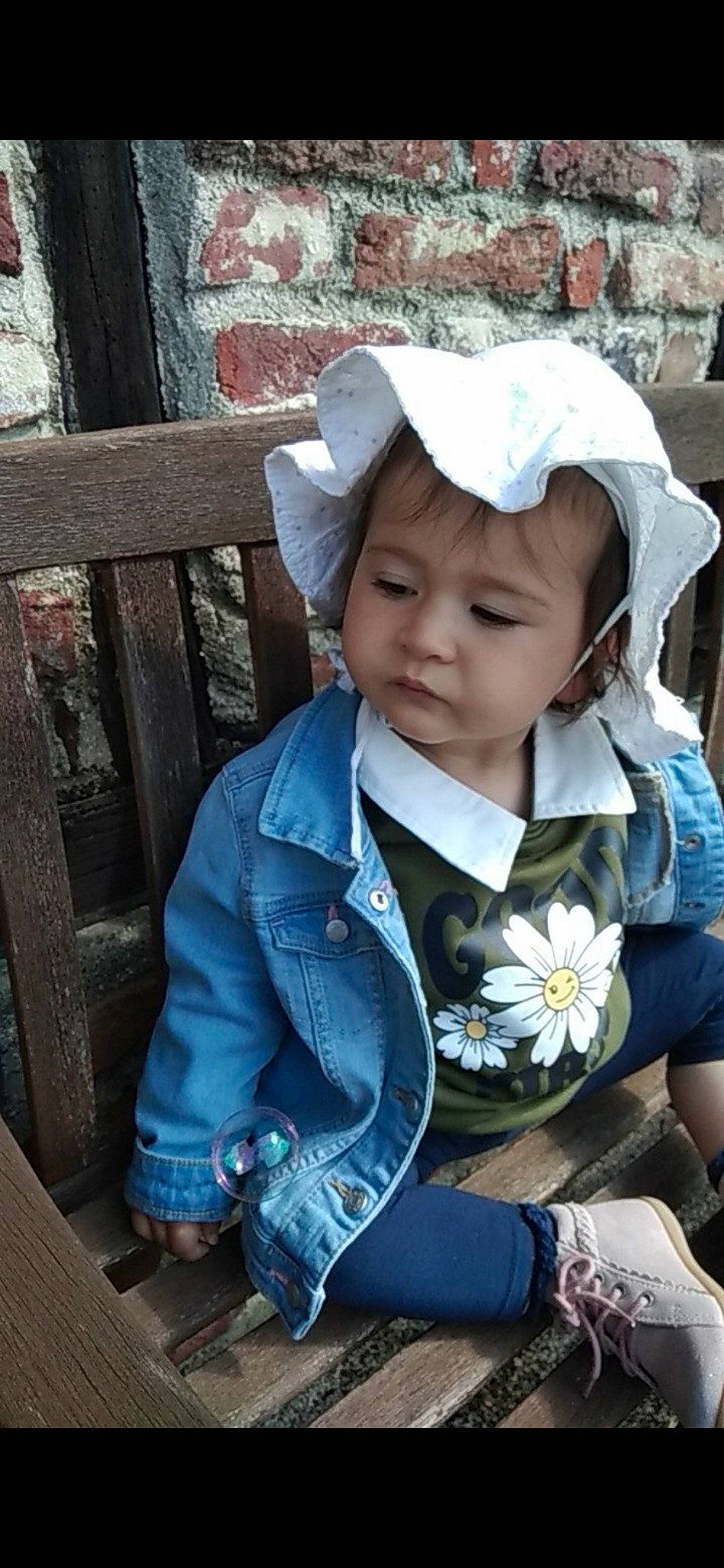 Aaliyah participe au concours pour gagner de l'argent avec cette photo : baby, baby_toddler_clothing, cap, child, clothing, denim, electric_blue, fashion_accessory, flower, grass, happy, hat, headwear, leisure, person, sitting, skin, smile, sun_hat, toddler