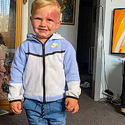 Jax joined the competition — help win amazing prizes! child, boy, smiling, indoor, nike_jacket, blue_jeans, carpet, cabinet, framed_picture, television, home, person, socks, standing, birthmark, doorway, curtains, furniture, room, casual_clothing