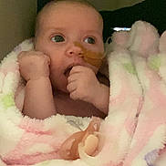 Alaiah Seddon is registered to the contest to win money with this photo: baby, infant, blanket, pacifier, medical_tube, wrapped, curious, indoor, child, young, face, hand, soft, pastel_colors, cozy, portrait, looking_away, skin, cute, newborn