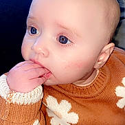 Alaiah Seddon is registered to the contest to win money with this photo: baby, child, face, blue_eyes, sweater, flower_pattern, hand, fingers, cute, portrait, closeup, infant, sitting, indoor, cozy, soft_light, skin, expression, thoughtful, clothing