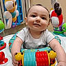 Cannon joined the competition — help win amazing prizes! baby, child, toy, activity_center, smile, indoor, playful, colorful, infant, happy, person, face, clothing, plastic, window, background, red, blue, yellow, green