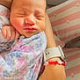 baby, newborn, sleeping, infant, arm, bracelet, watch, pillow, floral_clothing, hand, skin, peaceful, closeup, cute, person, child, portrait, resting, soft_light, indoor