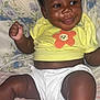 Jaloni joined the competition — help win amazing prizes! baby, child, smiling, yellow_shirt, bow, curly_hair, diaper, sitting, happy, indoors, bed, blanket, floral_pattern, striped_bedding, cute, portrait, infant, skin, face, expression