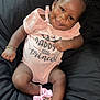Jaloni joined the competition — help win amazing prizes! baby, infant, smiling, pink_bow, pink_outfit, bracelet, black_background, cute, child, happy, portrait, footwear, hair_accessory, sitting, person, indoors, dressed_up, accessory, cuteness, relaxed