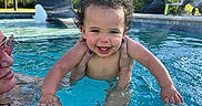Madden joined the competition — help win amazing prizes! toddler, child, pool, water, smile, curly_hair, adult_hands, sunlight, outdoor, swimming, blue_water, house, tree, grass, leisure, happy, summer, vacation, recreation, family