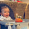 toddler, high_chair, birthday_cake, candle, celebration, child, smiling, indoor, woven_chair, table, decorations, adult, clapping, happy, curly_hair, food, party, family, home, festive