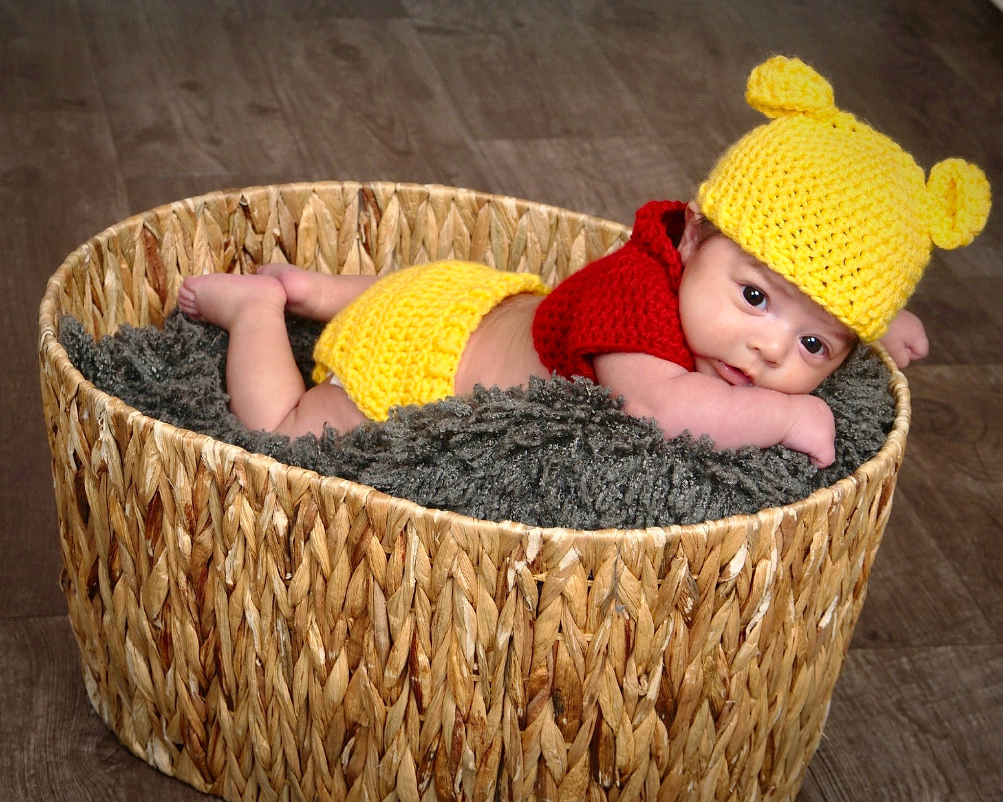 Arielle joined the competition — help win amazing prizes! baby, baby_toddler_clothing, basket, beanie, cap, child, comfort, fun, grass, headwear, knit_cap, people_in_nature, person, rectangle, sitting, storage_basket, textile, toddler, wicker, wood