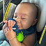 Nio is registered to the contest to win money with this photo: baby, blue_cloth, car_interior, car_seat, child, child_safety, close_up, comfort, cute, face, green_toy, hand, indoor, infant, nap_time, seatbelt, skin, sleepy, toy, warning_label