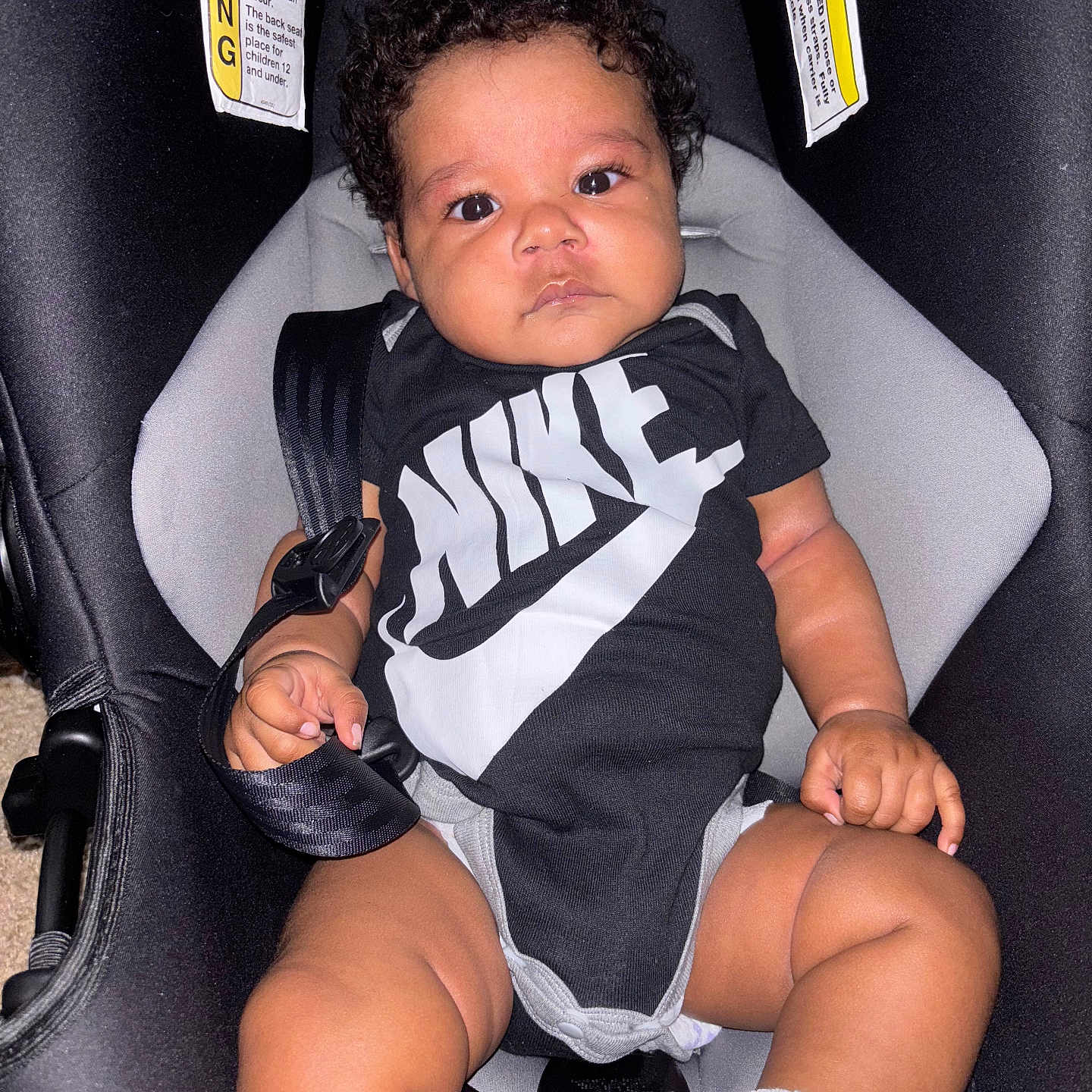 Sevyen joined the competition — help win amazing prizes! baby, black_clothing, car_seat, child, curly_hair, cute, face, hand, indoor, infant, legs, nike, onesie, portrait, safety, sitting, sock, straps, toddler, young